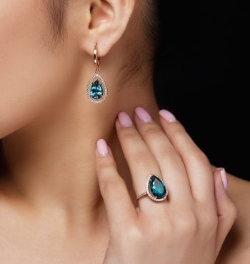 Model shows earrings and ring with beautiful blue precious stones